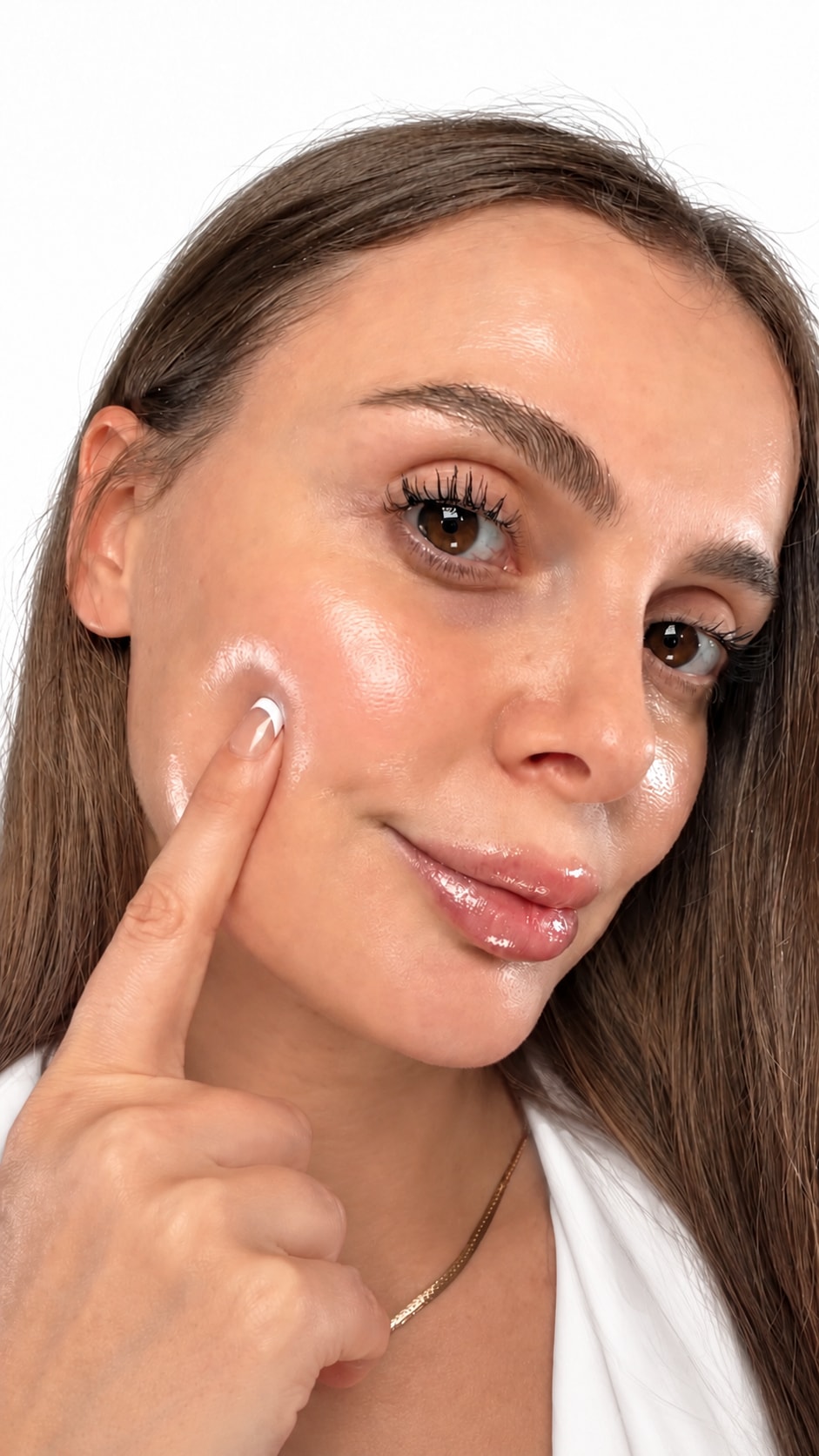 Albina Mavriqi with glass skin, touching her cheek, on a white background