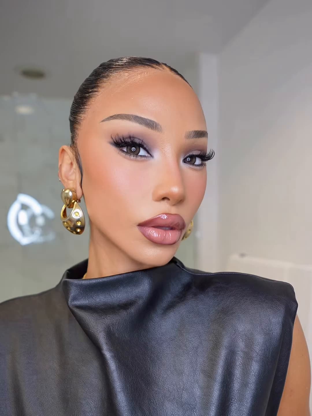 Melly looking into the camera with a finished smoky-eye makeup look.
