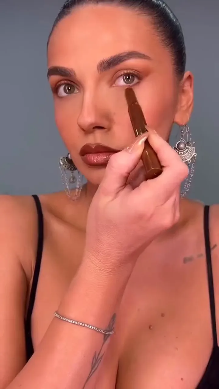 CA Agency creator applying makeup in a bold color cosmetics campaign video